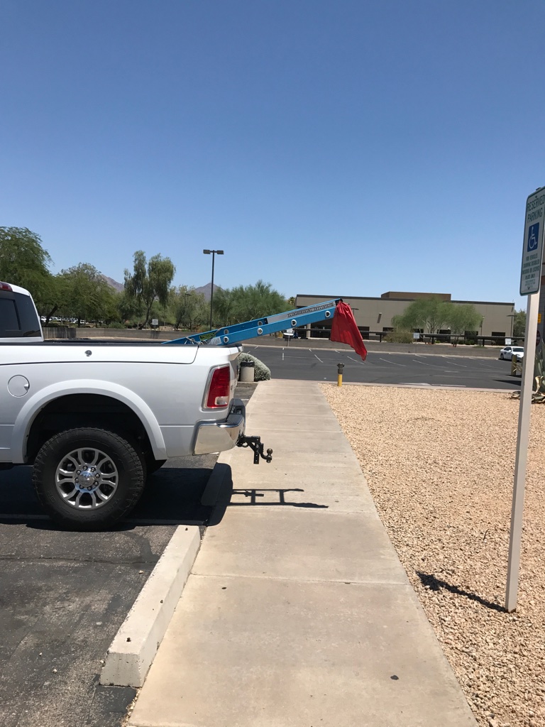 Ladder Flag fully displayed to Warn The Public walking on the side walk about ladder safety